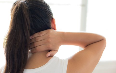 Brunette woman with stiff neck